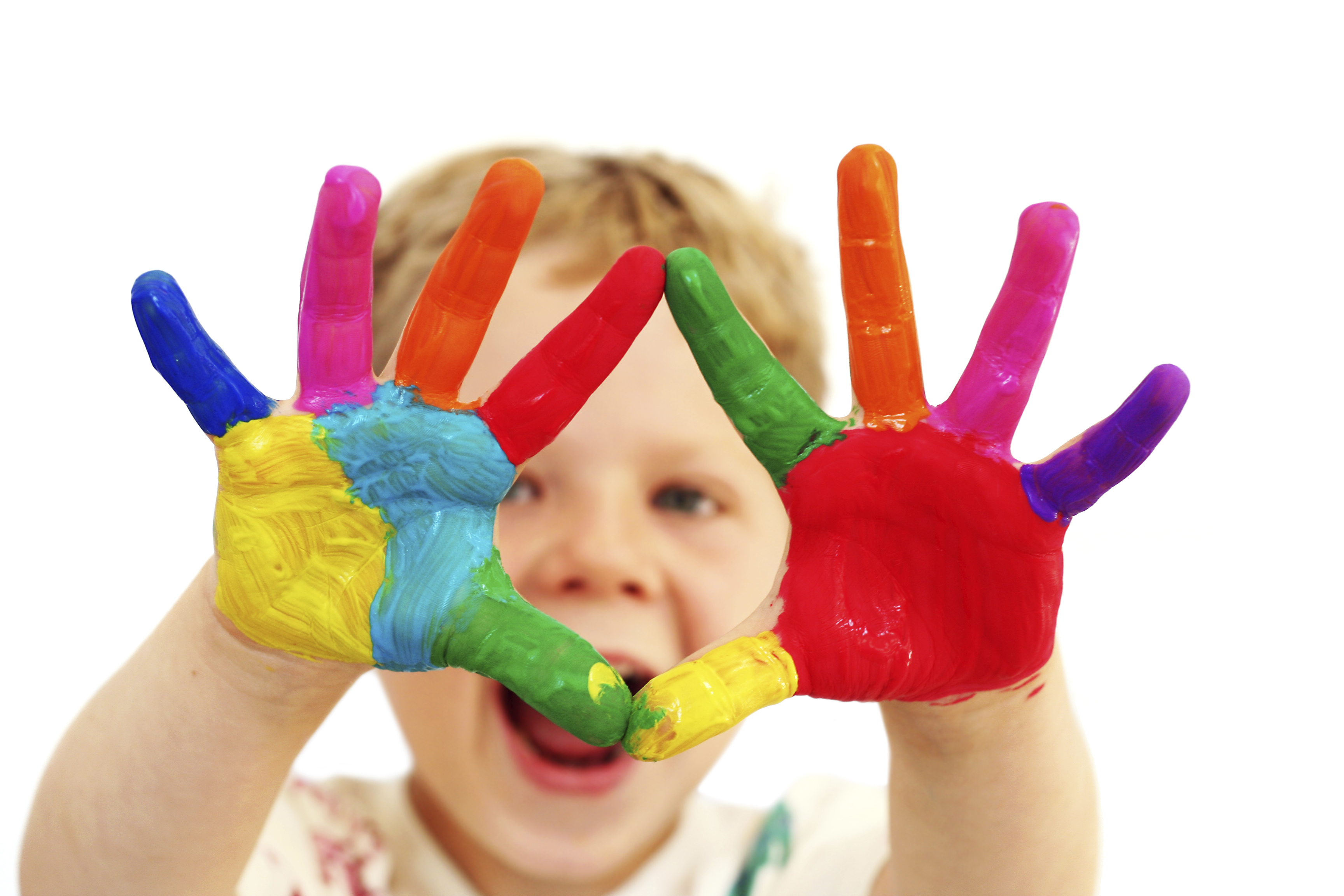 Five year old boy with hands painted in colorful paints ready for hand prints