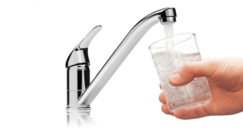 Glass filled with drinking water from tap, isolated on the white background.