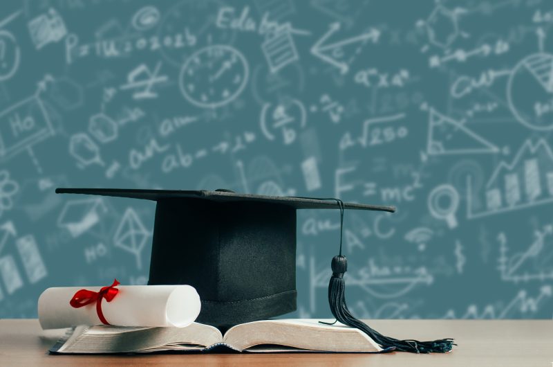 Concept of education for student or student success. College and university tuition for education, investment, textbooks on the table